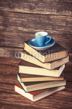 Fototapety Books and cup of coffee on wooden background.