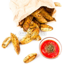 Fototapety French fries potato wedges with hot red  sauce in recycled kraft