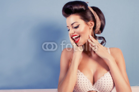 Fototapety Beauty smiling pinup girl on blue wall