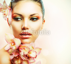 Fototapety Beautiful Girl With Orchid Flowers. Beauty Woman Face