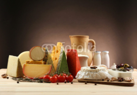 Naklejki Tasty dairy products on wooden table, on dark background