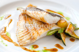 Naklejki Grilled turbot fish with vegetables.