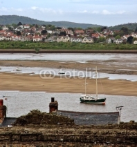 Obrazy i plakaty Small town and fishing - boat on low-tide