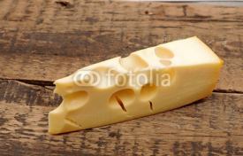 Fototapety piece of cheese on a wooden  background