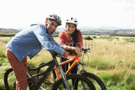Fototapety Young Couple Cycling In Countryside