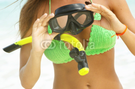 Fototapety Woman is holding a mask for snorkeling