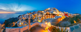 Fototapety Panoramic famous view, Old Town of Oia or Ia on the island Santorini, white houses and windmills at sunset, Greece