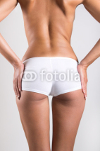 Naklejki Woman with perfect body checking cellulite