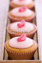 Fototapety Row of pink cupcakes