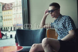 Fototapety Elegant young man sitting in a bar