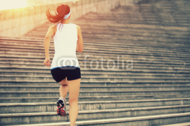 Fototapety  young fitness woman running up on stairs