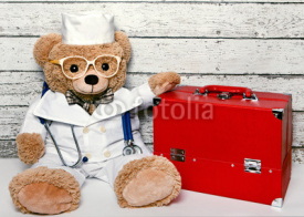 Naklejki Teddy bear in medical clothing with the suitcase doctor