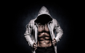 Naklejki strong athletic man on black background