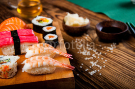 Naklejki Wonderful sushi set, oriental theme on the old wooden table
