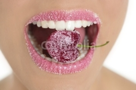 Naklejki Cherry with sugar between woman teeth
