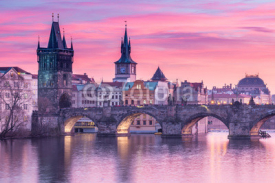 Charles Bridge in Prague with sunset sky in background, Czech Republic.