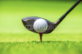 Naklejki Golf ball behind driver at driving range