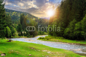 Fototapety camping place near mountain river at sunset