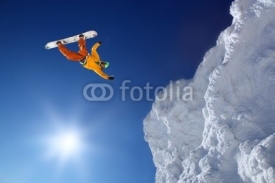 Naklejki Snowboarder jumping against blue sky