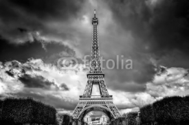 Naklejki Eiffel Tower seen from Champ de Mars park in Paris, France. Black and white