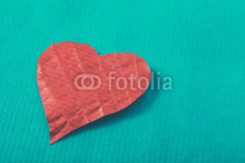 Naklejki Red heart, isolated on green background
