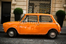 Naklejki Retro car orange color purity in the street