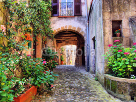 Fototapety Arched cobblestone street in a Tuscan village, Italy