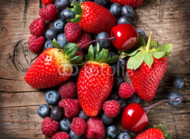Fototapety Berries on Wooden Background. Spring Organic Berry