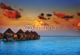 Fototapety houses on piles on water at the time sunset