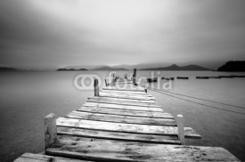 Fototapety Looking over a pier and boats, black and white