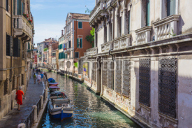 Fototapety Narrow canal among old colorful brick houses in Venice