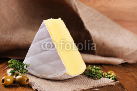 Fototapety Tasty Camembert cheese with thyme and olives, on wooden table