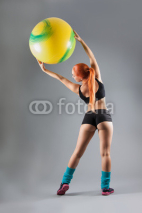 Health and Fitness woman in gym outfit with a Pilates ball