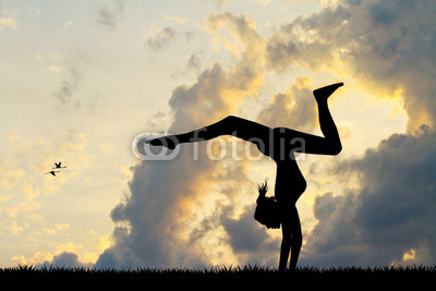 Girl does contortion at sunset