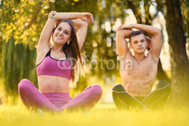Fototapety Sporty couple relaxing after fitness and yoga exercises.