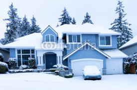 Front view of home during winter snowfall