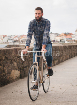 Naklejki Hipster man riding in  a fixie bike