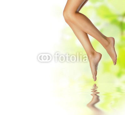 healthy sexy slender female legs over spring background