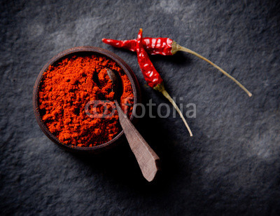 Red pepper spices on stone background