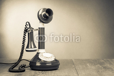 Retro rotary telephone on table for vintage background