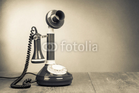 Naklejki Retro rotary telephone on table for vintage background