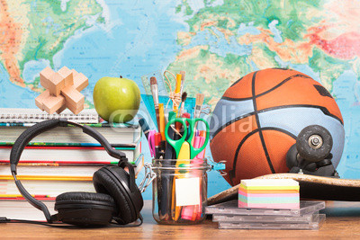 School accessories on desktop with map in the background