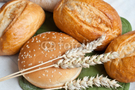 Fototapety Freshly baked traditional rolls with ears of wheat grain