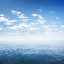 Fototapety blue sky over sea or ocean water surface