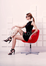 Naklejki Sexy woman sitting on a chair. Fashion shot
