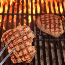 Two Beef Steaks On The Hot BBQ Flaming Grill