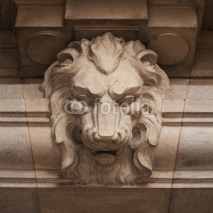 Naklejki Muzzle ferocious lion carved in stone