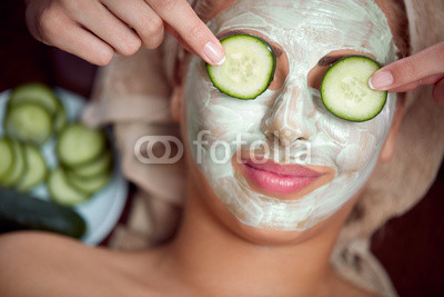 young girl with a mask for skin face