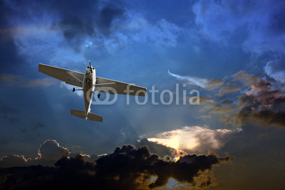 Small fixed wing plane against a stormy sky