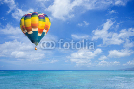 Naklejki Hot air balloon over ocean and clouds blue sky